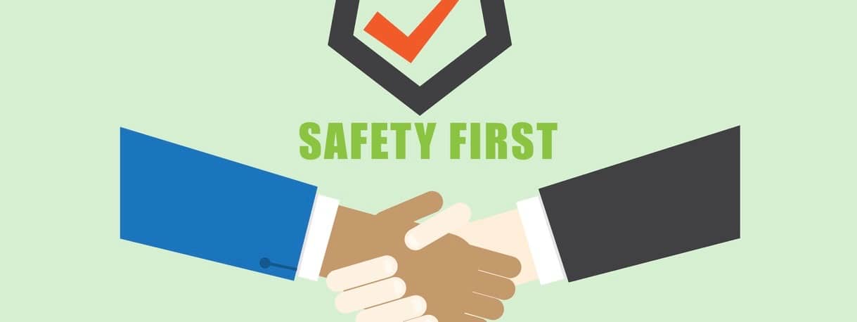 Technician handshake with safety first logo