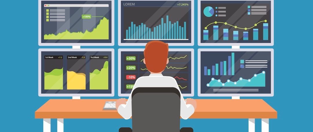 Businessman or stock market trader working at desk with six monitor showing data.